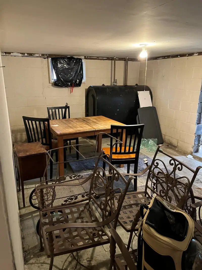 Shed interior with exposed framing and stored junk, Mastic, NY