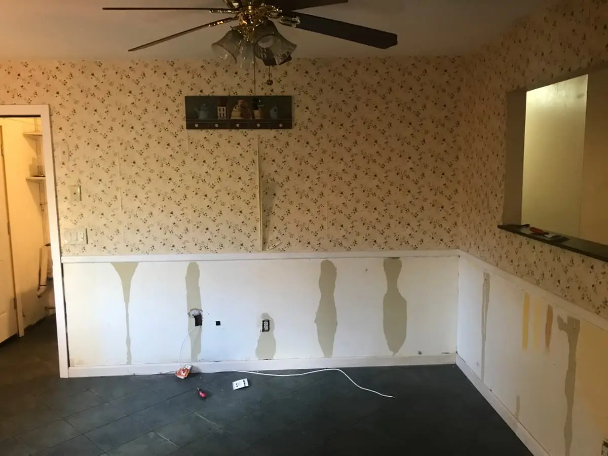Selling an inherited house in Mastic: dining room with patched wainscoting and old wallpaper