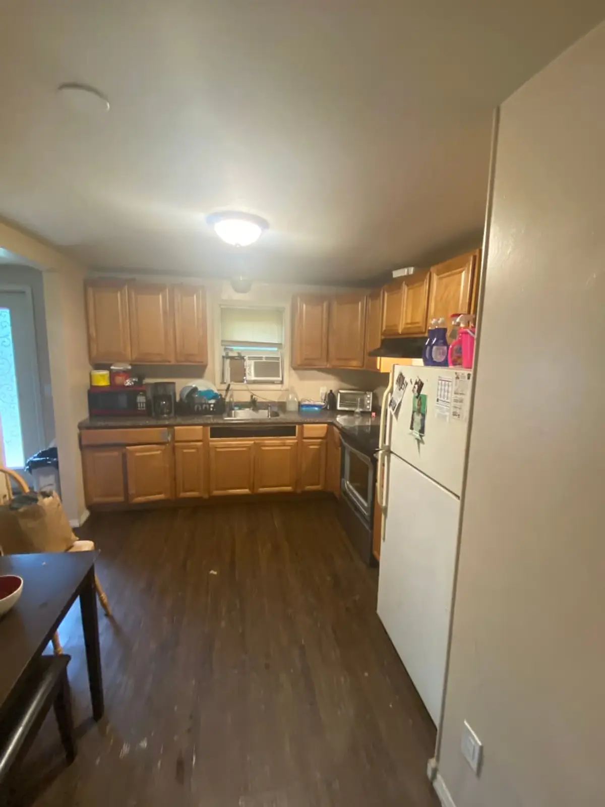 Wondering what your Mastic house is worth: kitchen with maple cabinets and a white fridge