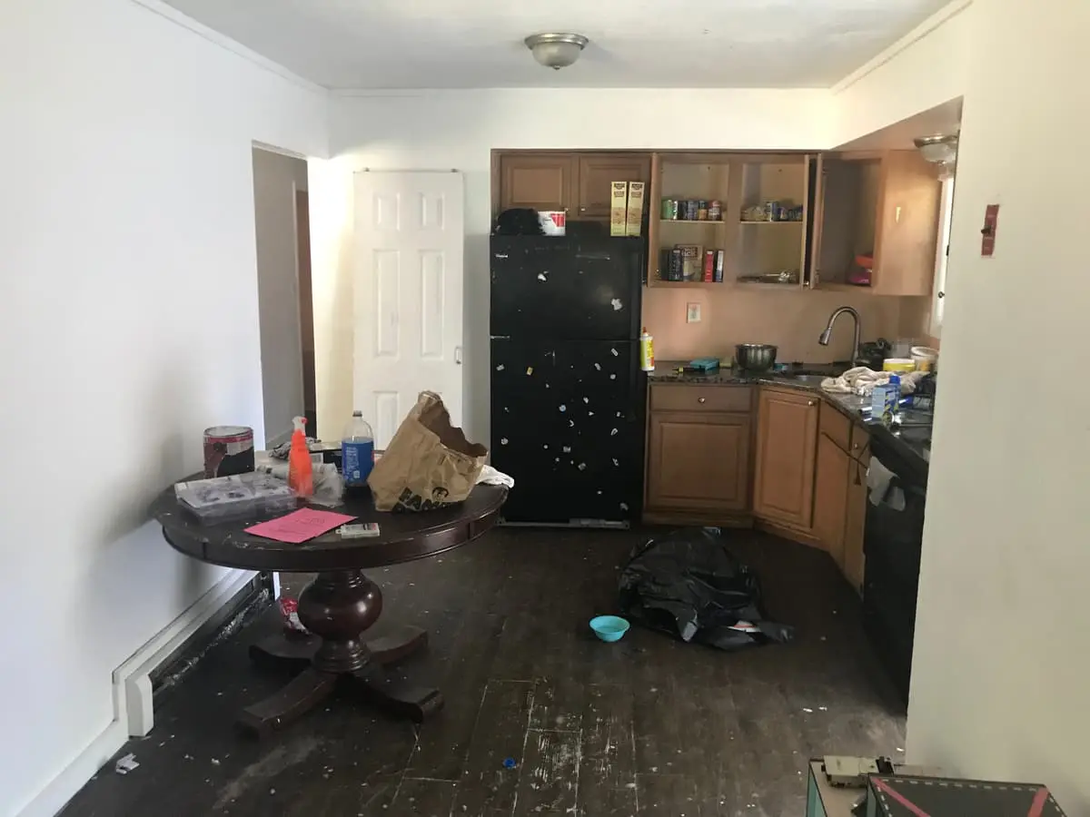 Selling estate property as an executor in Mastic: kitchen with oak cabinets and a cluttered table