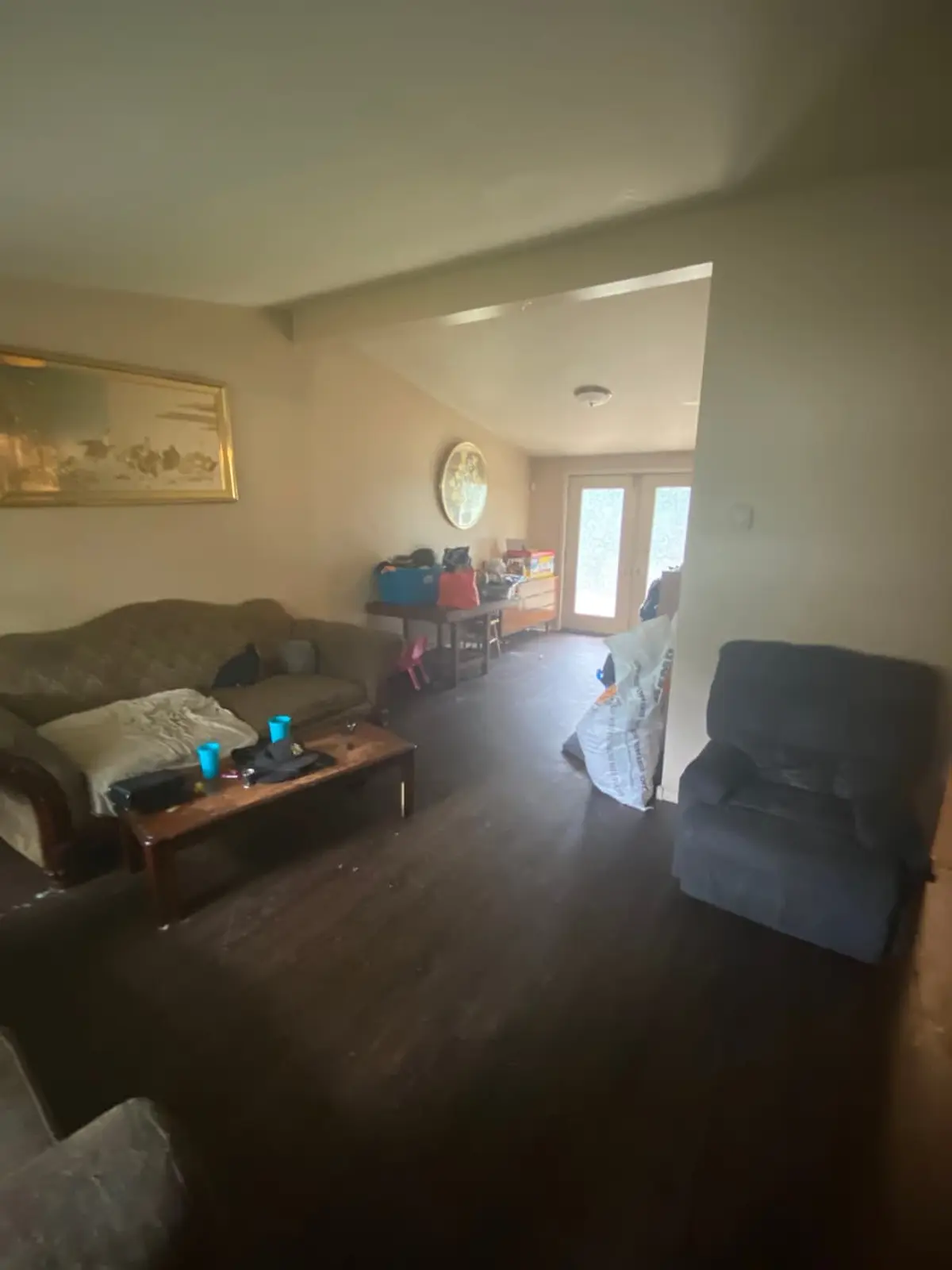 Behind on mortgage payments in Mastic: lived in living room with a sofa and recliner