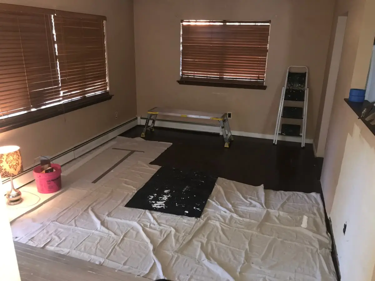 Selling a house in pre-foreclosure in Mastic: room with drop cloths and painting gear set out