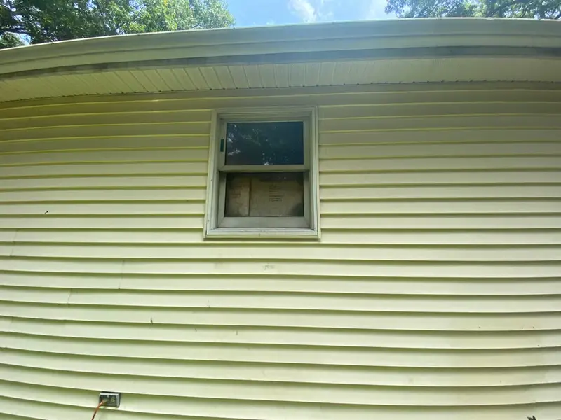 Side wall with a boarded up window, Mastic, NY